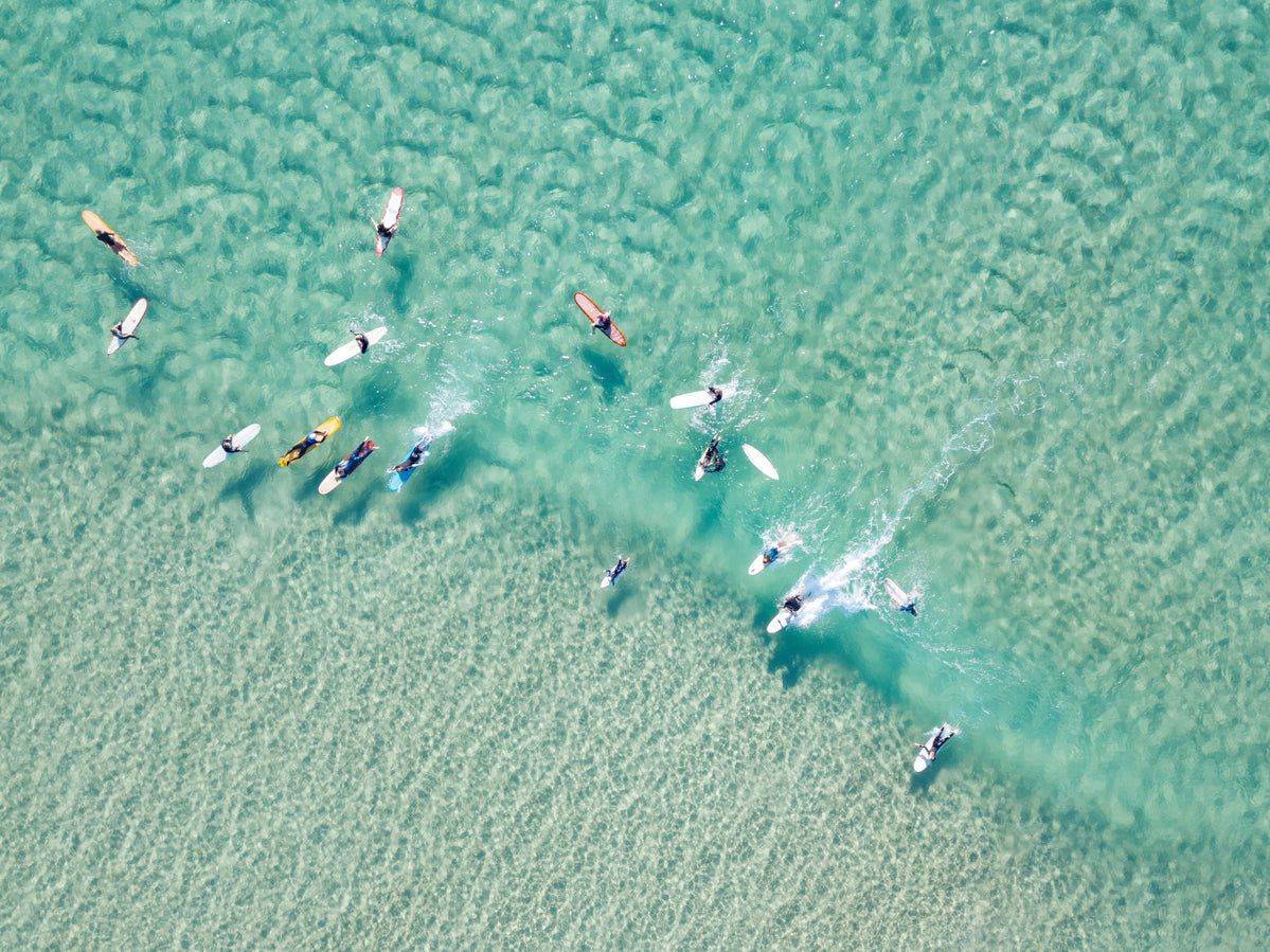 Crystal Clear Waters With Surfers